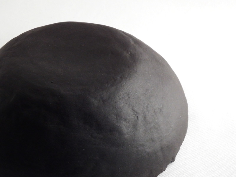 Smooth finish for black papier maché clay with clear, matte acrylic spray