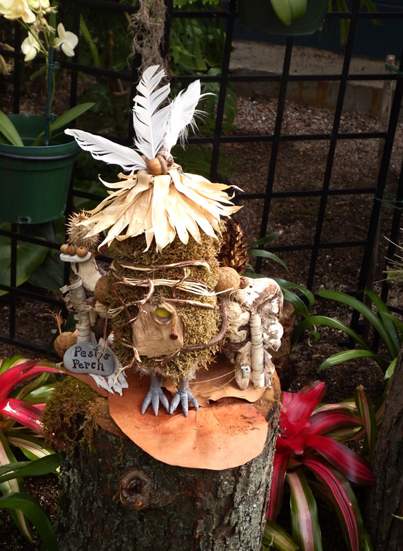 Fairy house with feathers, "bird feet", leaves, moss, bark and acorns