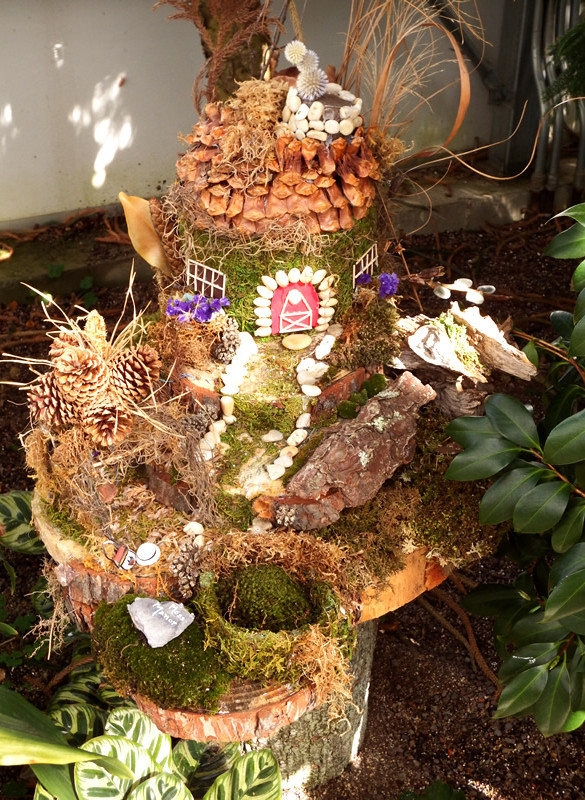 Fairy home with pine cone roof and pistachio shell doorframe and walkway