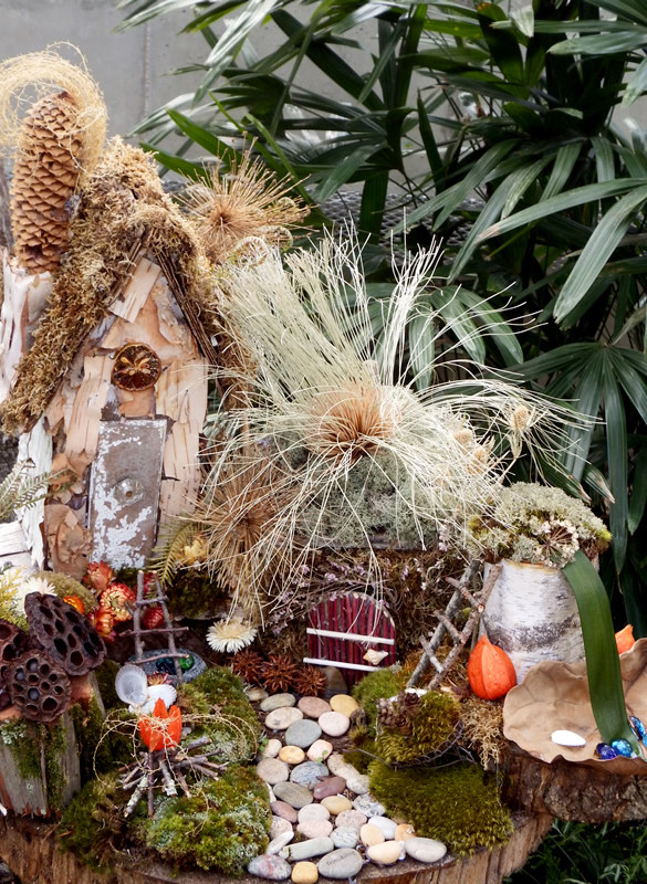 Fairy home with old doorknob, stone walkway and seed pods